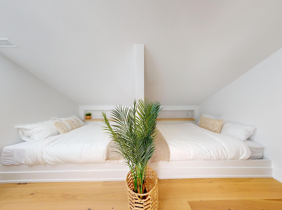 Bright loft bedroom with twin beds and woven details